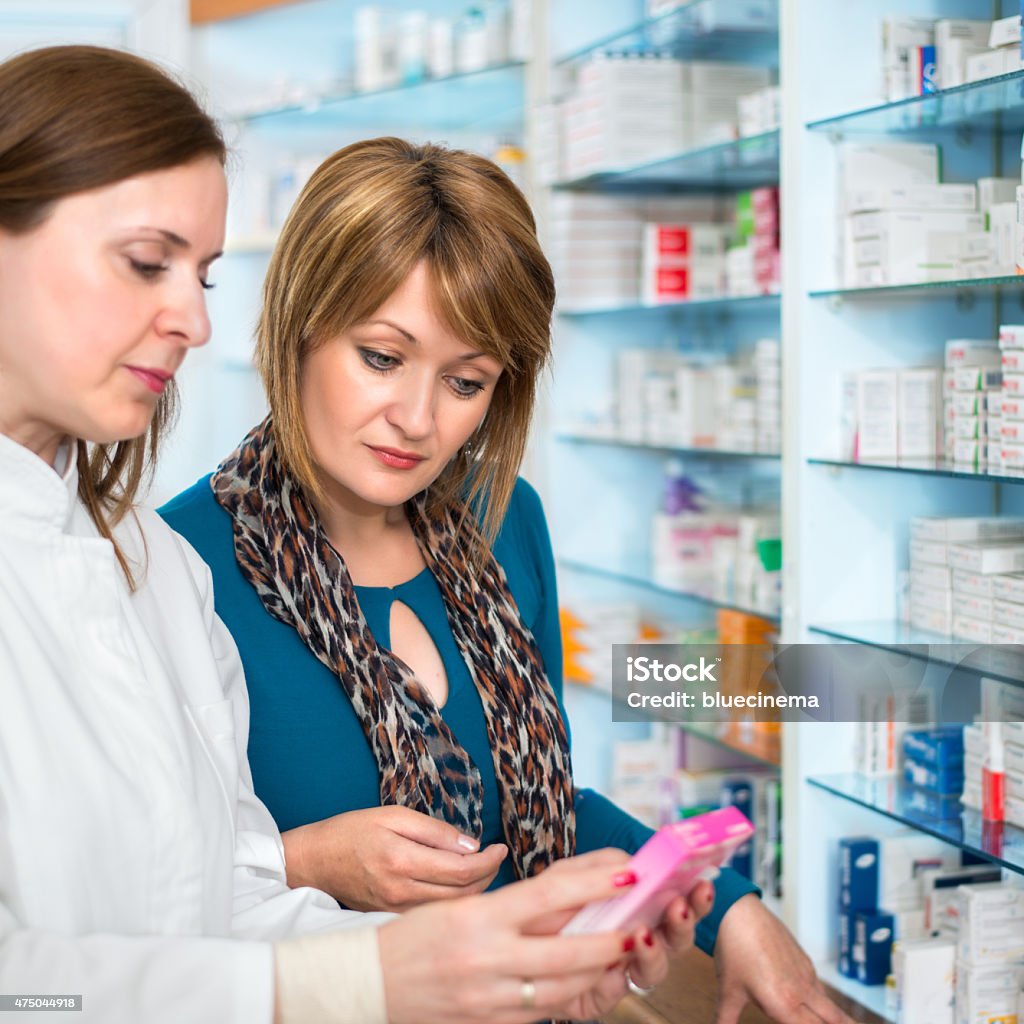 Pharmacist with a patient Pharmacist with a patient talking about prescription medicine Pharmacy Stock Photo