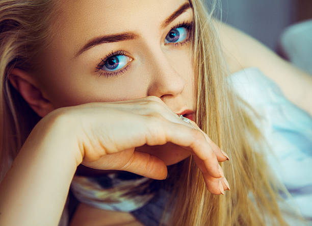 istock Stunning young blonde woman looking at camera with blue eyes 475045228