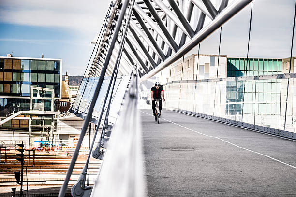In the early morning the city is populated by sportive commuters wearing backpacks and going at work in the business district of the town.