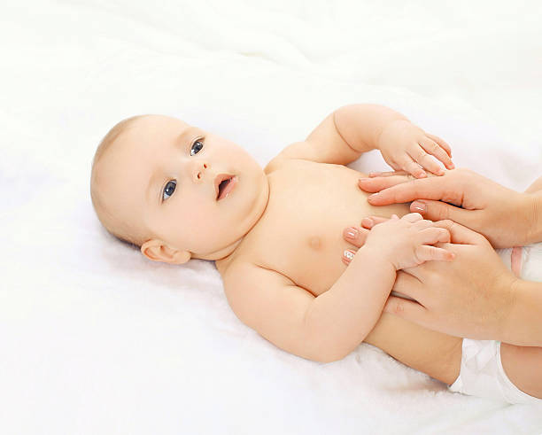 istock Baby massage lying on the back at home 475046010