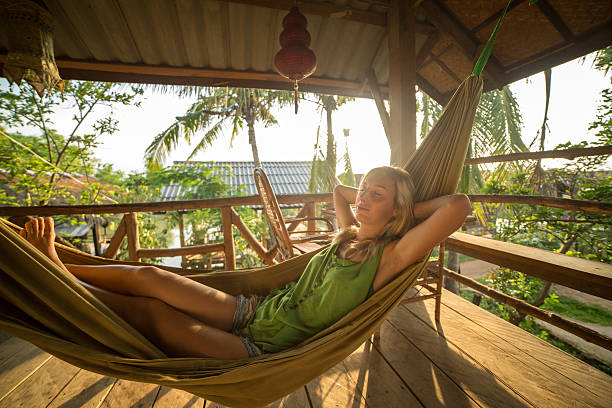 istock Girl on hammock at sunset relaxing 475046848