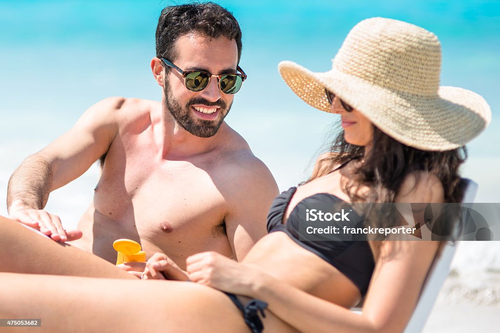 Happiness couple at the seaside relaxing Happiness couple at the seaside relaxing on sunbeds Beach Stock Photo