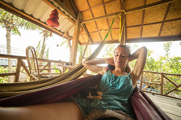 istock Woman and cat relaxing on hammock 475053814