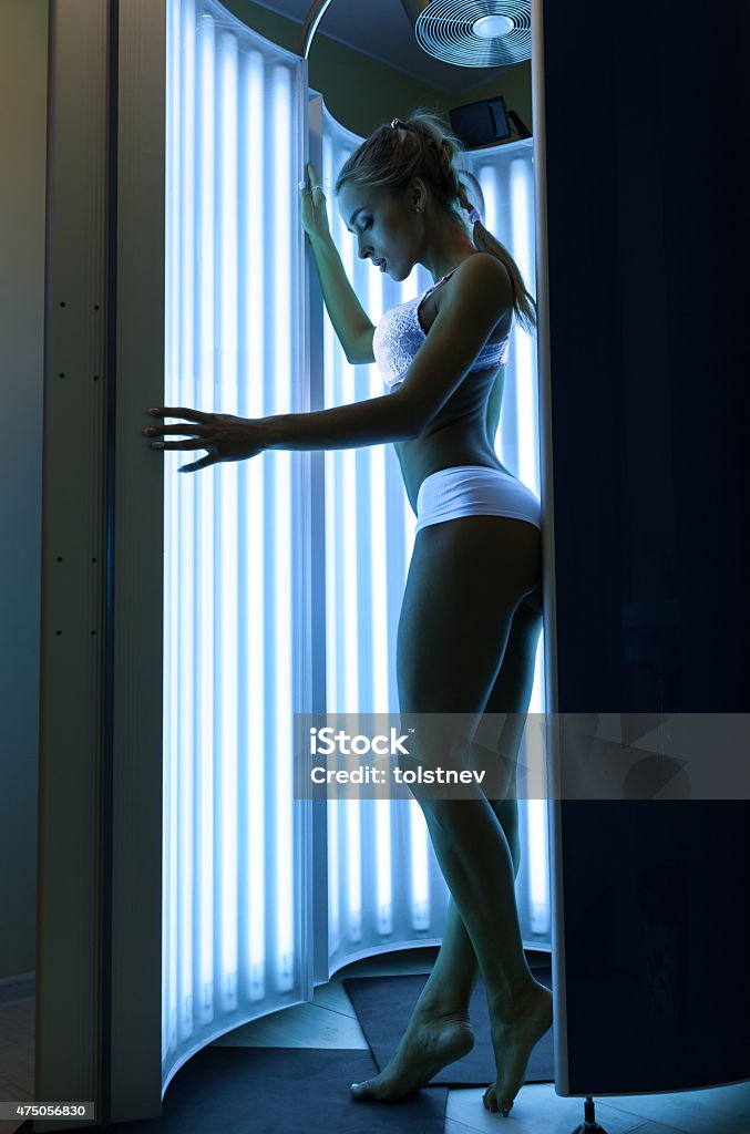 Woman in the solarium Woman getting tan in the solarium 2015 Stock Photo