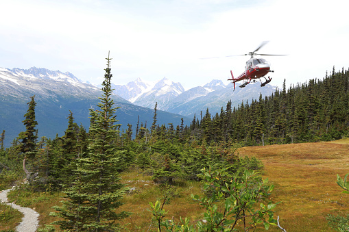 Rescue helicopter arrives to save hiker, in emergency on the mountains.