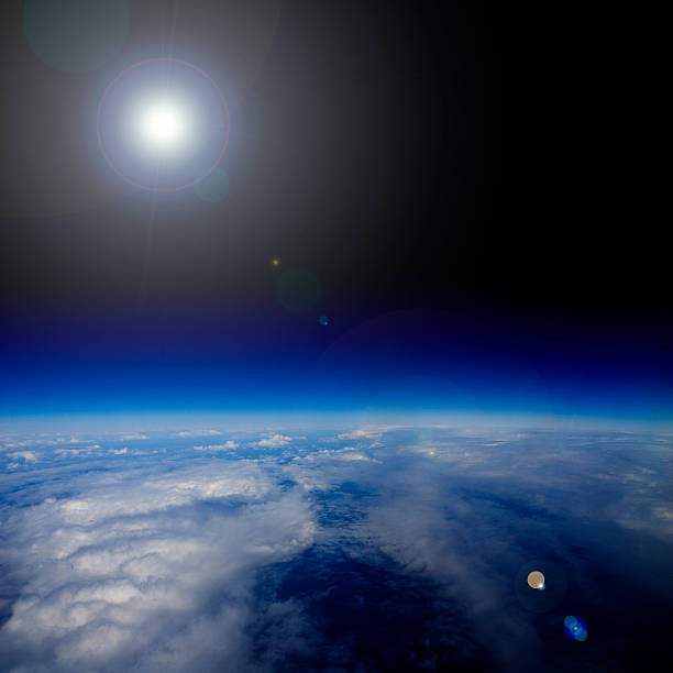 istock The dazzling sun with lens flare over planet Earth. 475058112