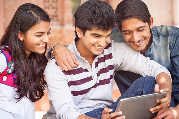 istock Group of Young Indian Friends Looking at Tablet Computer 475058116
