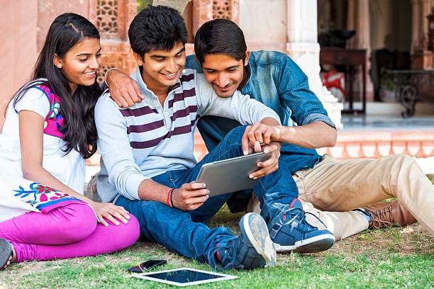 istock Group of Young Indian Friends Looking at Tablet Computer 475058124