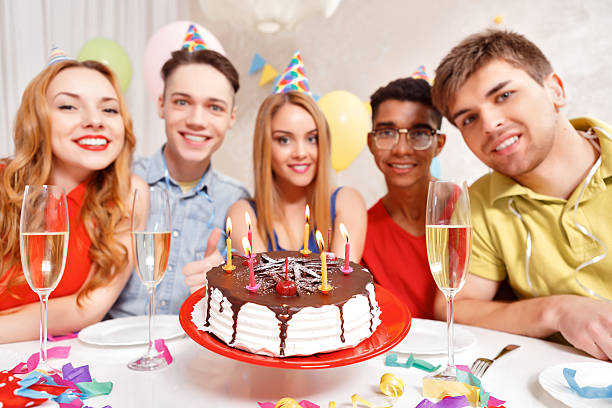 istock Young people celebrating a birthday sitting at the table 475058398