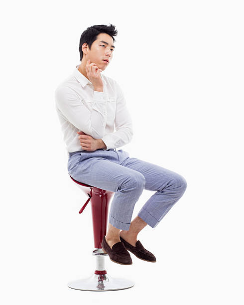 istock Young Asian man thinking on the chair. 475058923
