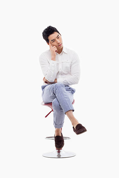 istock Young Asian man thinking on the chair. 475058961