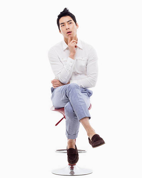istock Young Asian man thinking on the chair. 475058969