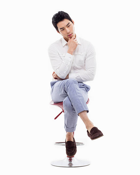 istock Young Asian man thinking on the chair. 475058971