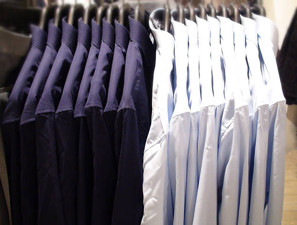 istock Long Sleeve Shirts Hanging On A Rail Rack 475060984