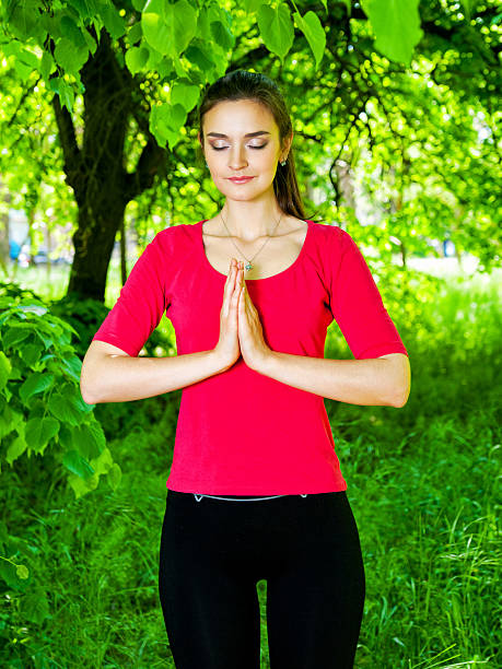 istock Girl meditating in park 475062418