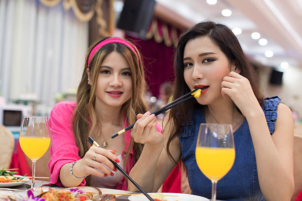 istock Happy young people having meal together 475062784
