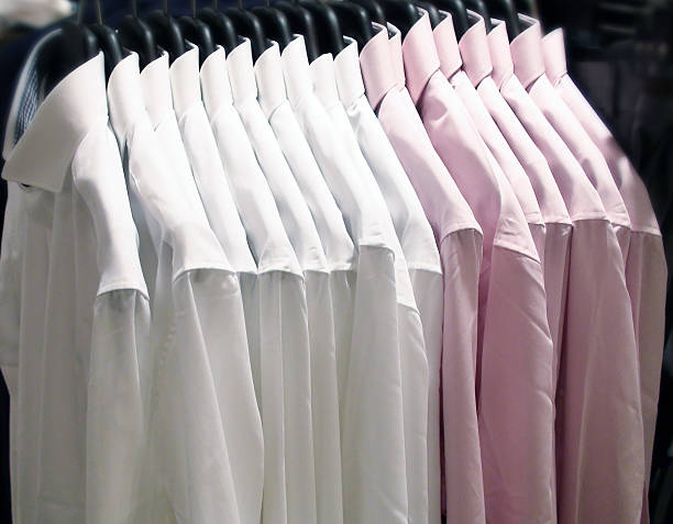 istock Shirts Hanging On A Rail Rack In Retail Store 475064068