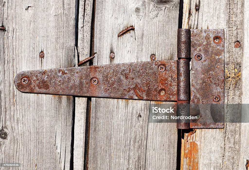 rusty aged iron hinge rusty aged iron hinge weathered gray wood doorOld and weathered wooden door on a white background 2015 Stock Photo