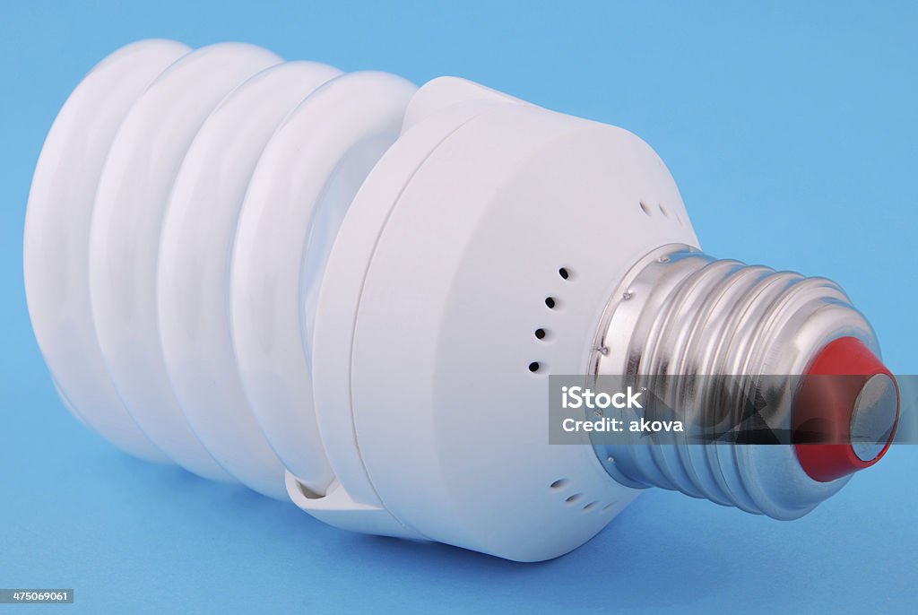 Lamp. Energy-saving electricity lamp Energy-saving electricity lamp on a blue background. Blue Background Stock Photo