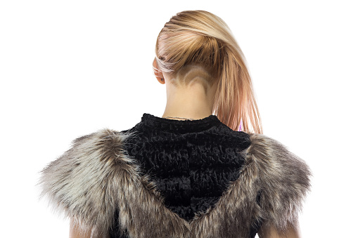 Photo of woman in fake fur jacket,  turned back on white background