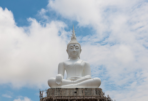 The white buddha made from cement with blue sky in Thailand Thailand