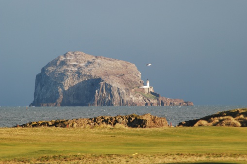 The Bass Rock and lighthouse from the Glen Golf Club at North Berwick, East Lothian, Scotland where the Scottish Seabird Centre is located.