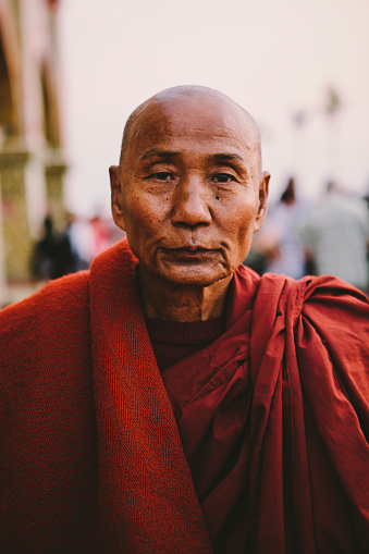 Mandalay, Myanmar - February 9, 2015: Portrait of peaceful buddhist monk looking at camera at Mandalay Hill. 