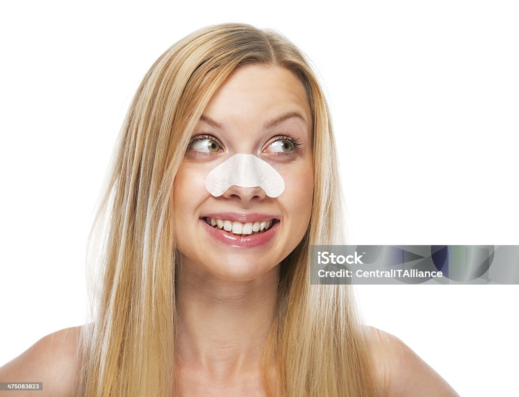 Portrait of smiling young girl with clear-up strips on nose Portrait of smiling young girl with clear-up strips on nose looking on copy space Adult Stock Photo