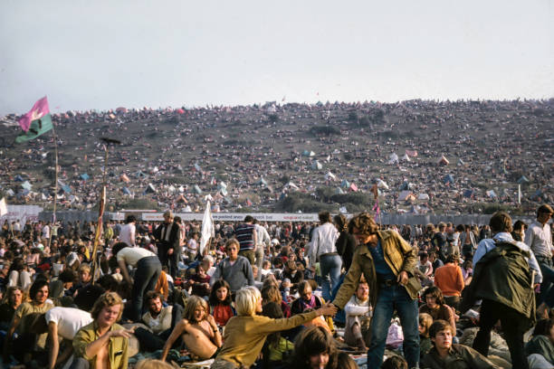 Isle of Wight Music Festival, 1970 Isle of Wight, England - August 30, 1970: Vintage photo of crowd attending the Isle of Wight Music Festival, attended by over 600,000 people.  Musical groups that performed included the Doors, The Who, Joan Baez, Jimi Hendirx, Kris Kristofferson, Donovan, the Moody Blues, Jethro tull, Richie Havens,  hippie photos stock pictures, royalty-free photos & images