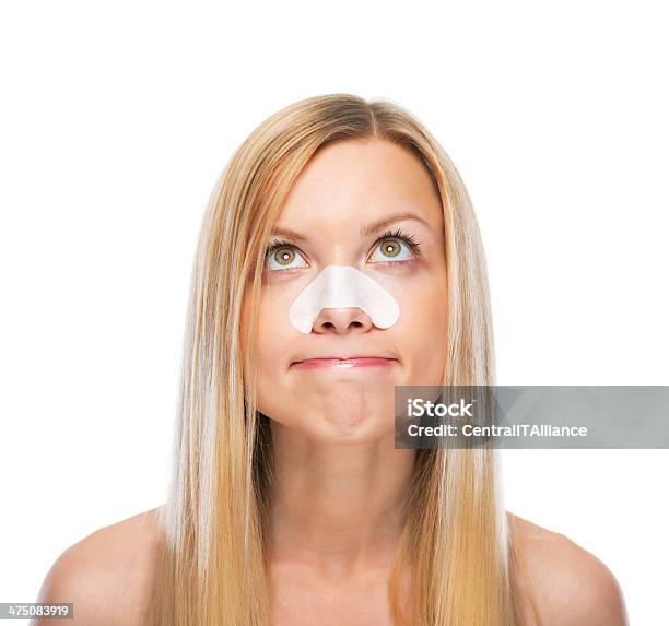 Portrait Of Concerned Young Girl With Clearup Strips On Nose Stock Photo - Download Image Now