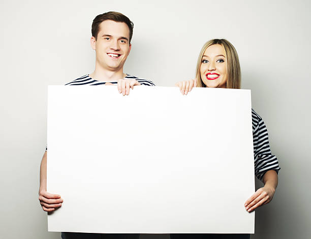 istock Couple holding a banner 475083960