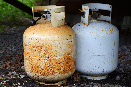 Two old rusty  dangerous gas/propane bottles.