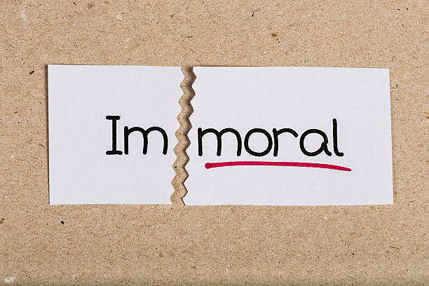 Two pieces of white paper with the word immoral turned into moral