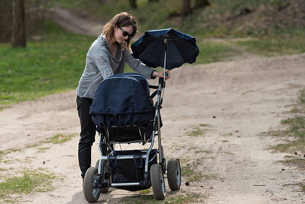 Mother gives milk to child during walk in the woods.