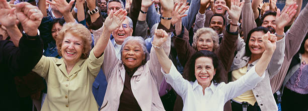 istock Large group of multi-ethnic people cheering with arms raised 475085125