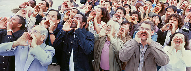 istock Panoramic shot of crowd shouting with hands on face 475085189