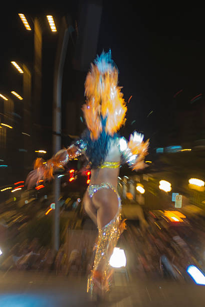 Carnival Parade Florianópolis, Santa Catarina, Brazil - February 01, 2013: A samba dancer, accompanied in the background by the samba school band, performs during the competition that selects the Queen of Carnival, a traditional contest that happens a few days before the Carnival parade, in the City Center of Florianópolis. mardi gras body painting stock pictures, royalty-free photos & images