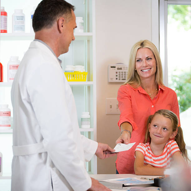 istock Mother and daughter at pharmacy. 475090756
