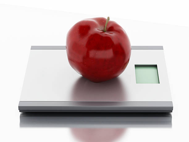 istock 3d Scales and apple. Diet concept. 475092738