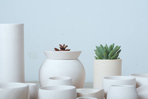 istock Not glazed pot on wood tableUnglazed white clay pots 475099364