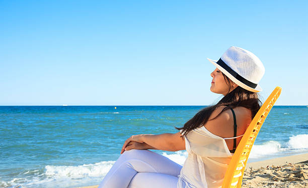 istock Woman on the beach 475100152