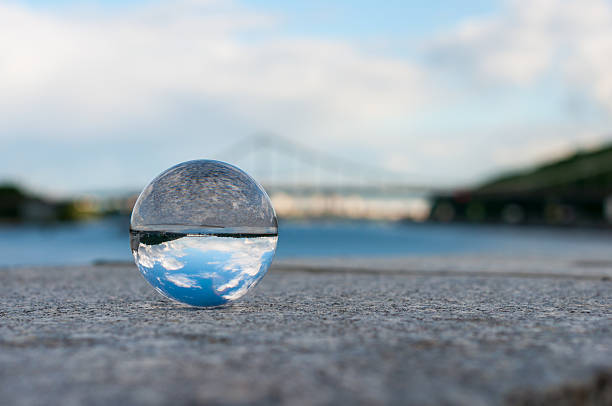 istock Glass transparent ball on bridge background and grainy surface. With 475100894