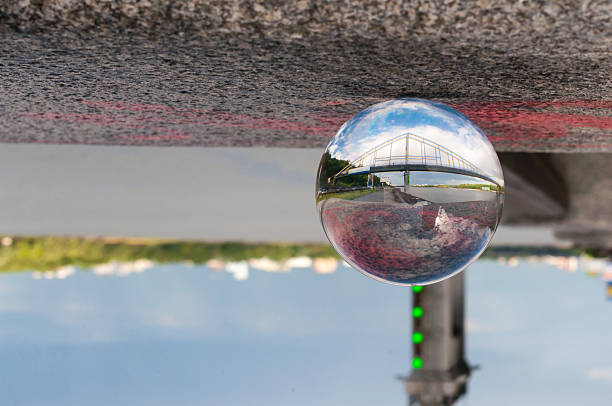 istock Glass transparent ball on bridge background and grainy surface. With 475100952