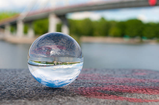 istock Glass transparent ball on bridge background and grainy surface. With 475101090