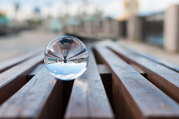 vidrio transparente sobre fondo de bola de láminas de madera.   con espacio vacío - equanimity fotografías e imágenes de stock