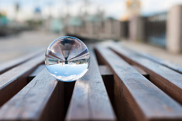 palla di vetro trasparente su sfondo in legno di ossatura.   con spazio vuoto - equanimity foto e immagini stock