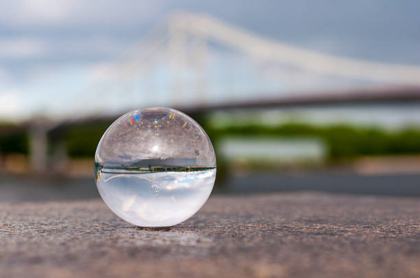 istock Glass transparent ball on bridge background and grainy surface. With 475104876