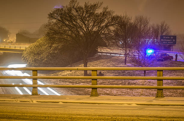 istock police helping injured driver after a crash during winter snowstrom 475105105