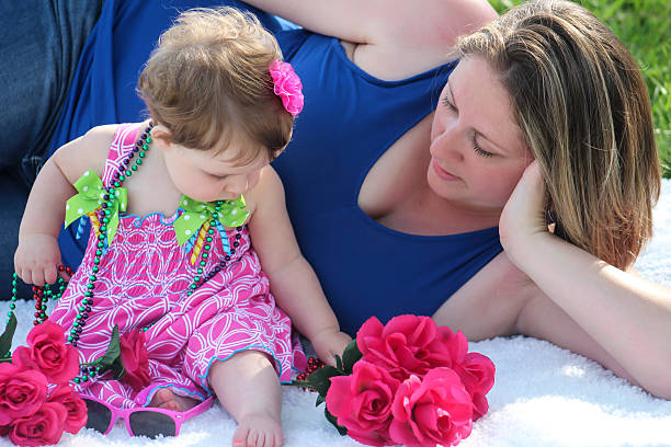 istock Mother and Daughter Surrounded by Flowers 475112578