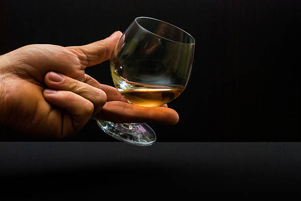 istock Cognac glass in human hand 475116324